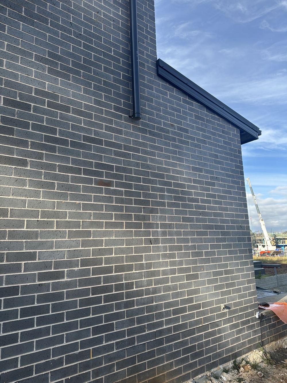 Brickwork stepping up in height with no articulation joint, found during a fixing stage inspection in Rouse Hill