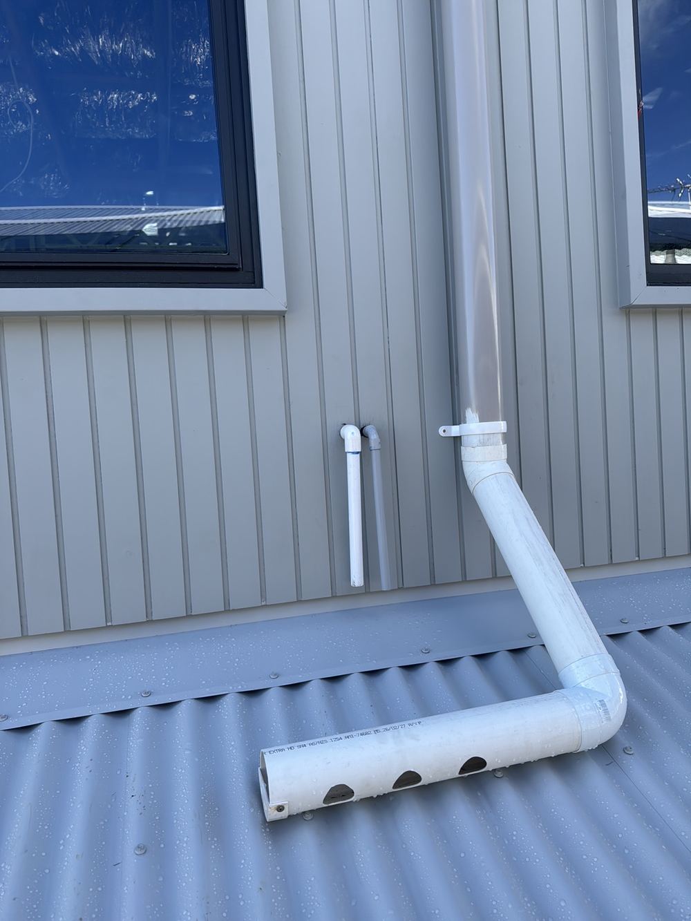 Air conditioner condensate draining onto roof flashing rather than an approved outlet, found during a lock-up inspection in Rouse Hill