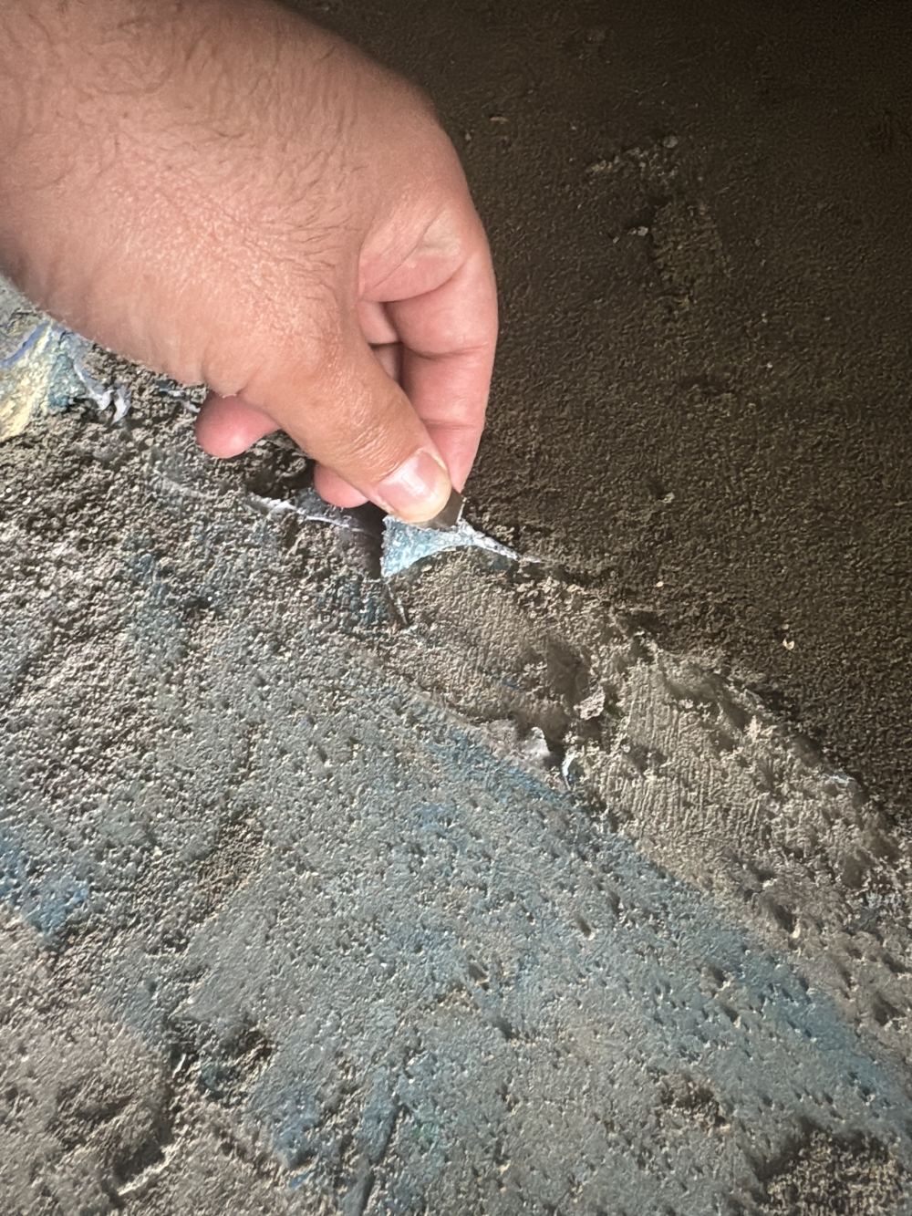 Shower membrane brushed on over an uncleaned slab, found during a fixing stage inspection in Rouse Hill