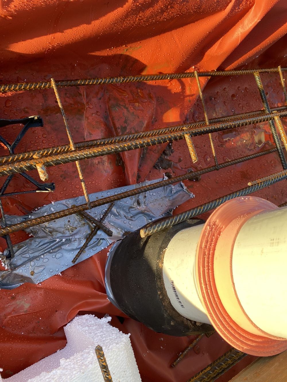 Mesh touching a service pipe where at least 25mm of clearance is needed, found during a slab pre-pour inspection in Rouse Hill