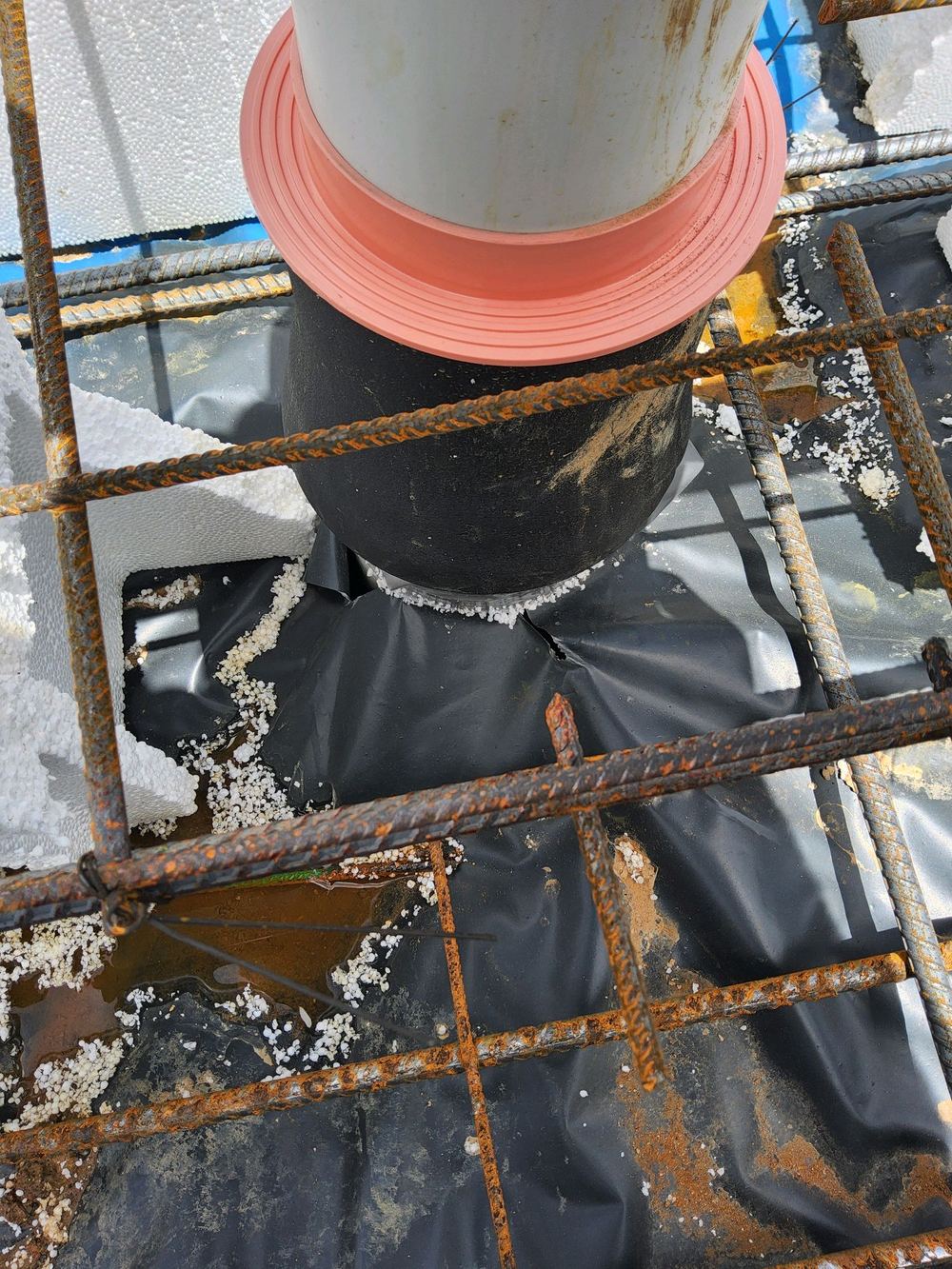 Vapour barrier joints left untaped, letting ground moisture rise into the slab, found during a slab pre-pour inspection in Rouse Hill