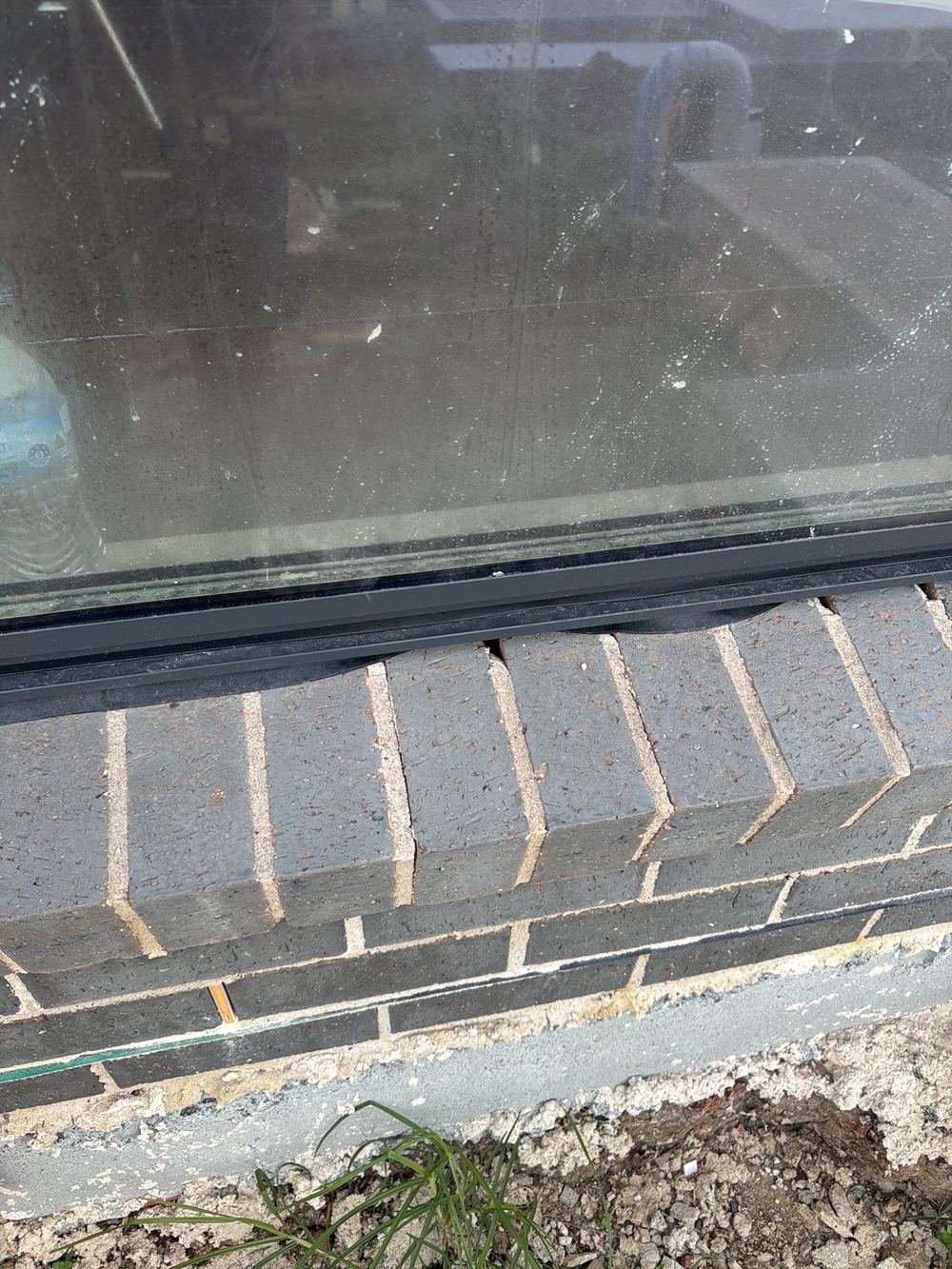 Window rubber flashing not seated between frame and brick, letting rain through, found during a fixing stage inspection in Rouse Hill